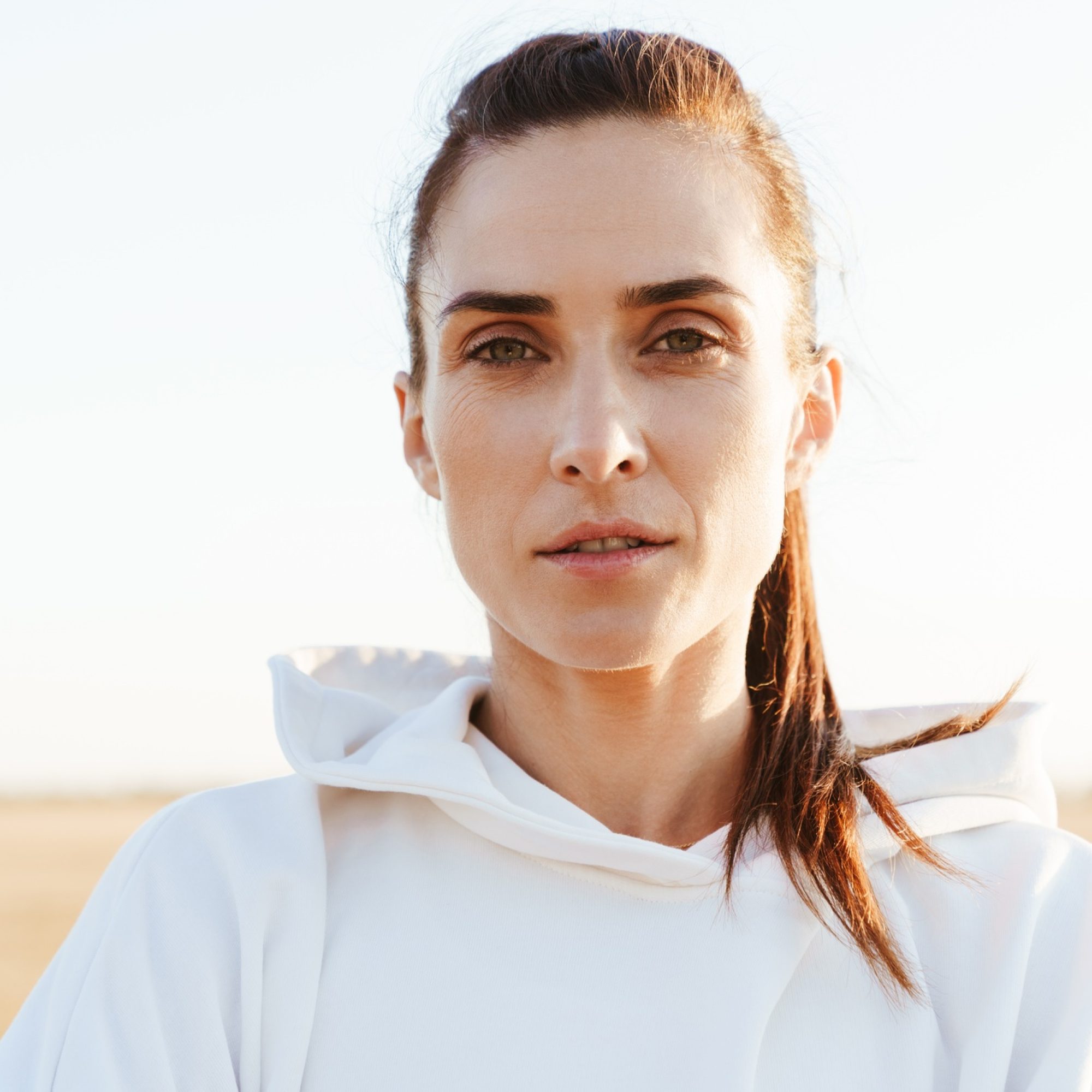 Image of adult beautiful sportswoman looking at camera while working out